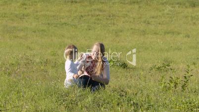 Mother and son on green grass.