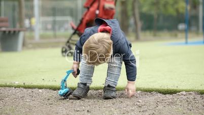 Boy playing with toy outdoor.