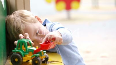 Boy playing with toy outdoor.