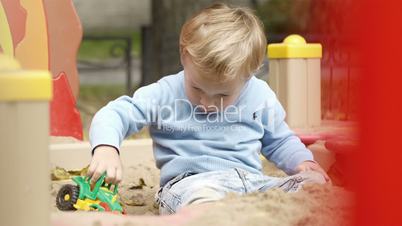 Boy playing with toy on playground.