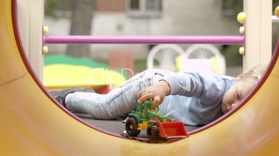 little boy playing with toy.