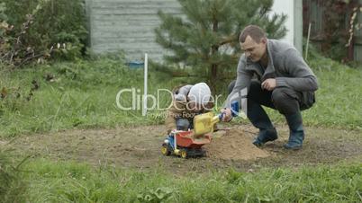 Father and son playing outdoors.