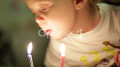Little boy blowing out the candles.