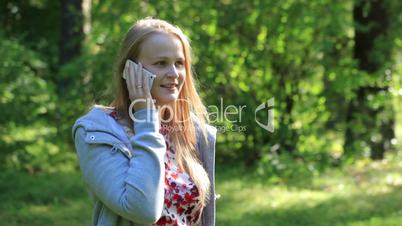 Woman chatting on her mobile phone outdoors