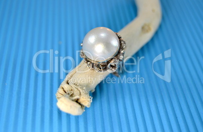 Pearl ring  on blue background