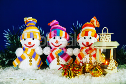 Three snowman with a lantern