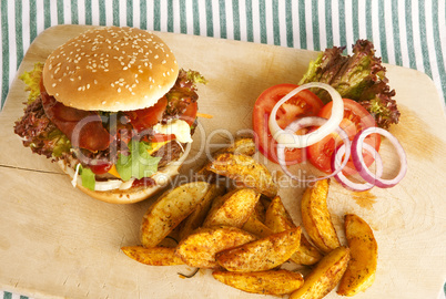 burger with potato wedges on board