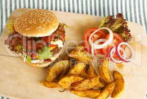 burger with potato wedges on board
