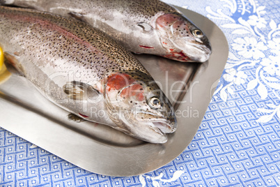 two fresh trout served on a tray