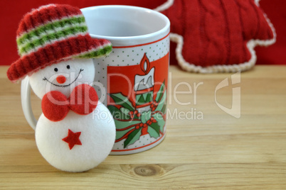 Mug with christmas decor and santa claus toy