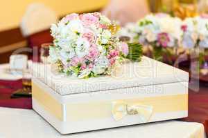 wedding table decoration with bride bouquet with gift box