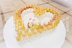 festive glasses arranged in a heart shaped form
