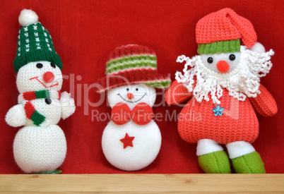Three snowmen santa on red background
