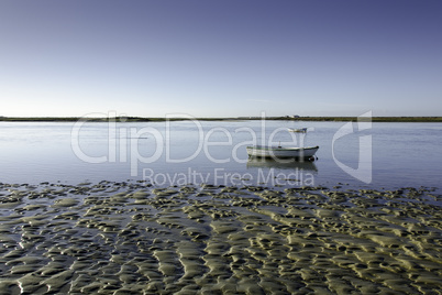 tidal flat with a small boat