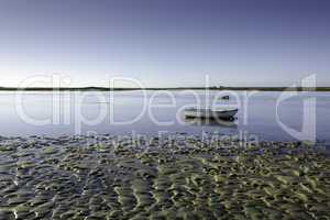 tidal flat with a small boat