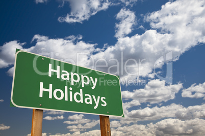 happy holidays green road sign over clouds and sky
