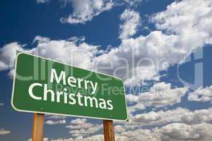 merry christmas green road sign over clouds and sky