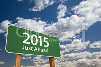 2015 just ahead green road sign over clouds and sky