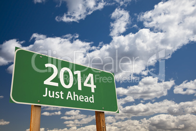 2014 just ahead green road sign over clouds and sky