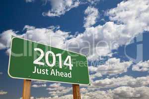 2014 just ahead green road sign over clouds and sky
