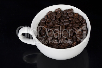 cup of full roast coffee beans