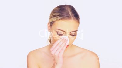 Beauty portrait of a woman cleansing her face
