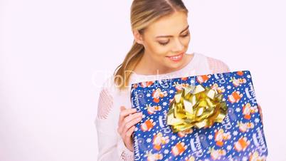 Smiling woman with a colourful Christmas gift
