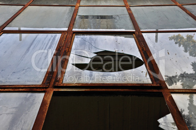 broken windows with rusty metal frame