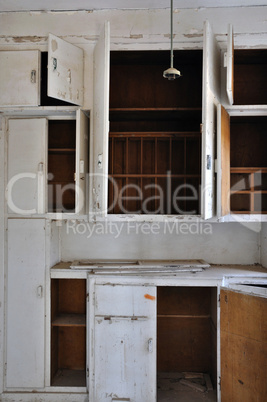 empty cupboards in abandoned kitchen