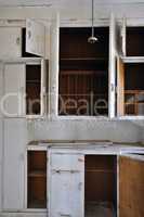empty cupboards in abandoned kitchen
