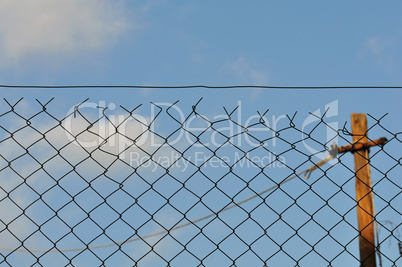 chain link fence and blue sky