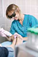 podiatrist doing a foot laser treatment