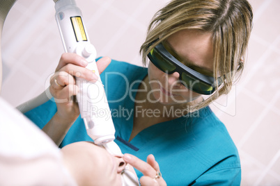 beautician doing laser skin treatment