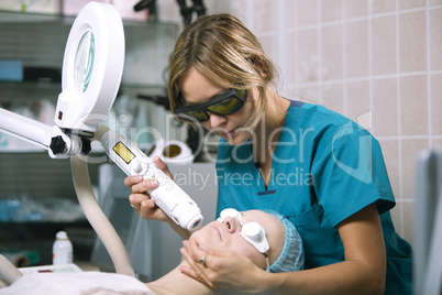 woman undergoing laser skin treatment