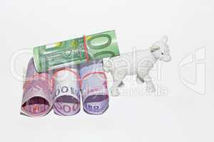 A white plastic sheep with a money carriage isolated