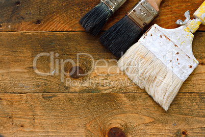 used paintbrushes on old wooden table