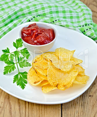 chips with tomato sauce on a board