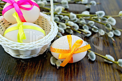 easter eggs with colored ribbons on a blackboard