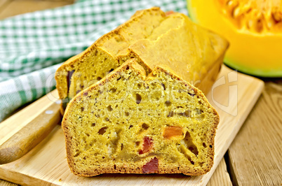 fruitcake pumpkin with candied fruit and a napkin on a board