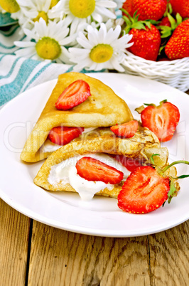 pancakes with strawberries and cream on the board