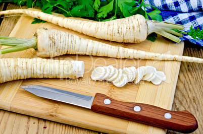 parsley root cut with a knife on board