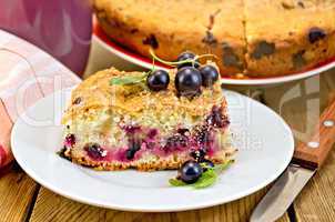 pie with berries of black currant and knife on board