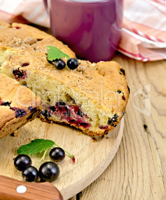 pie with berries of black currant on a board