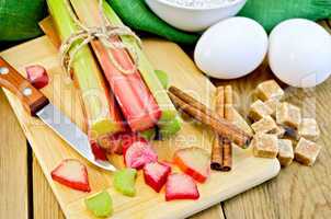 rhubarb with sugar and eggs on the board