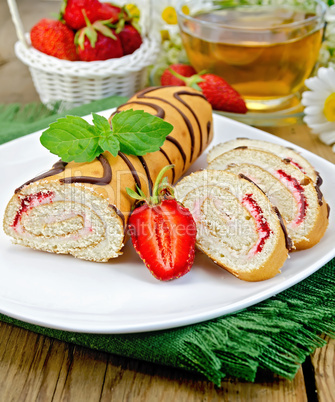 Roulade a cup of tea and strawberries on a board
