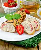 Roulade a cup of tea and strawberries on a board