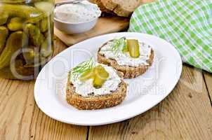 Sandwich with cream and pickles on a board