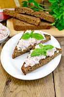 Sandwiches with cream of salmon with bread on the board