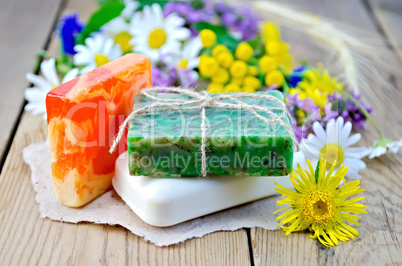 Soap homemade with wildflowers on the board