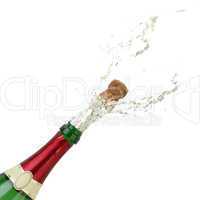 Champagner spritzt an Neujahr aus einer Flasche Sekt
